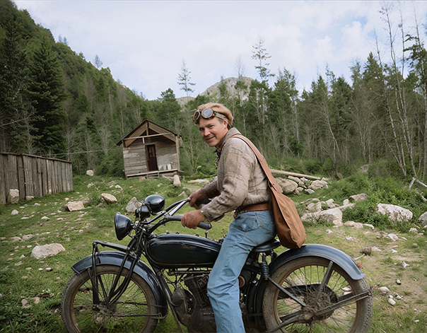 old photo of a guy on a motor bike after photo restoration in colour
