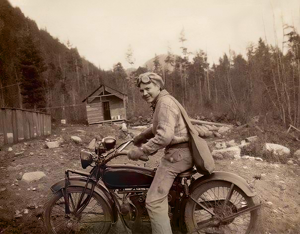 old photo of a guy on a motor bike after photo restoration