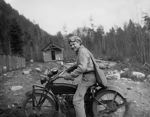 old photo of a guy on a motor bike after photo restoration